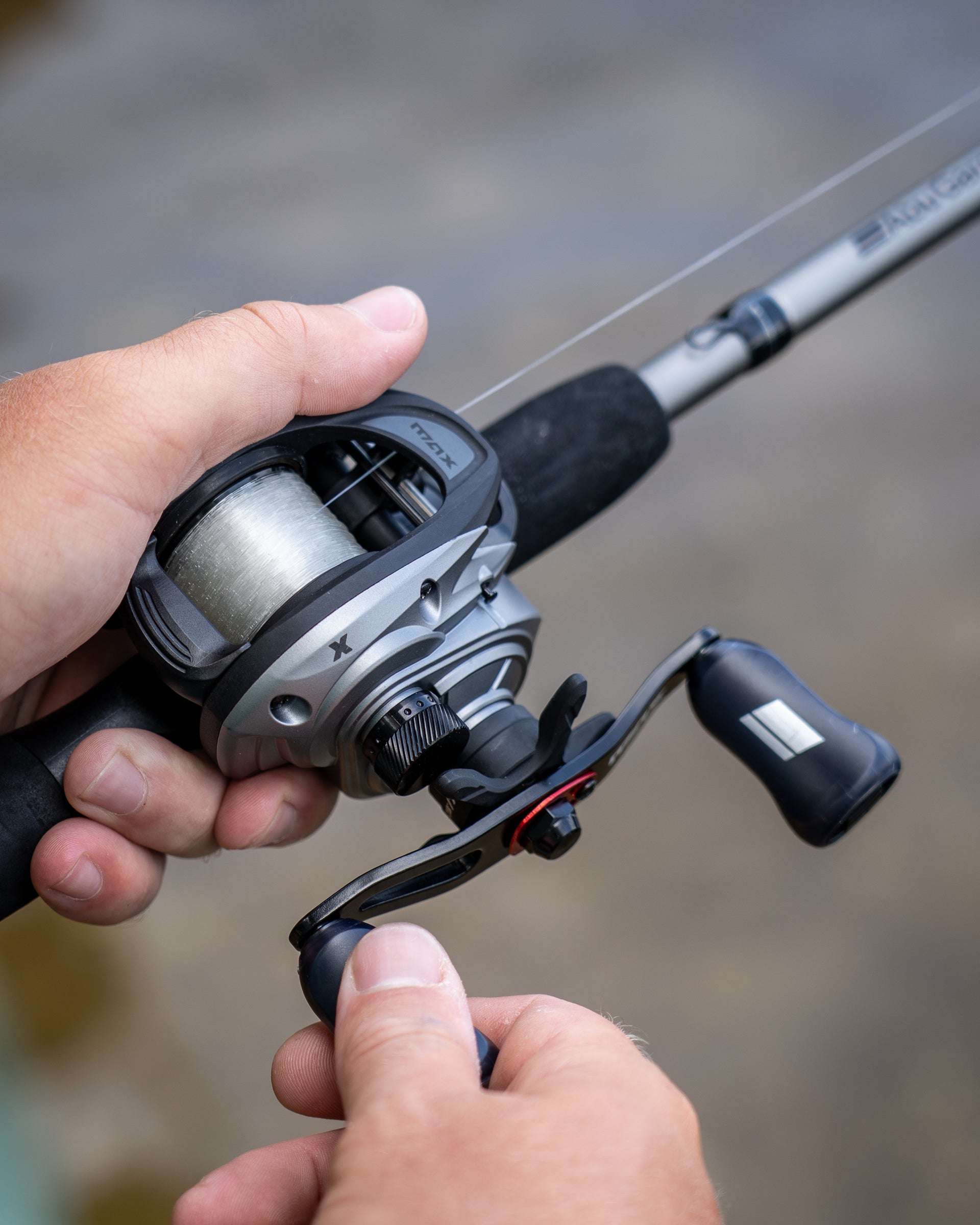 Abu Garcia Max X Low Profile Baitcast Combo in persons hand. 