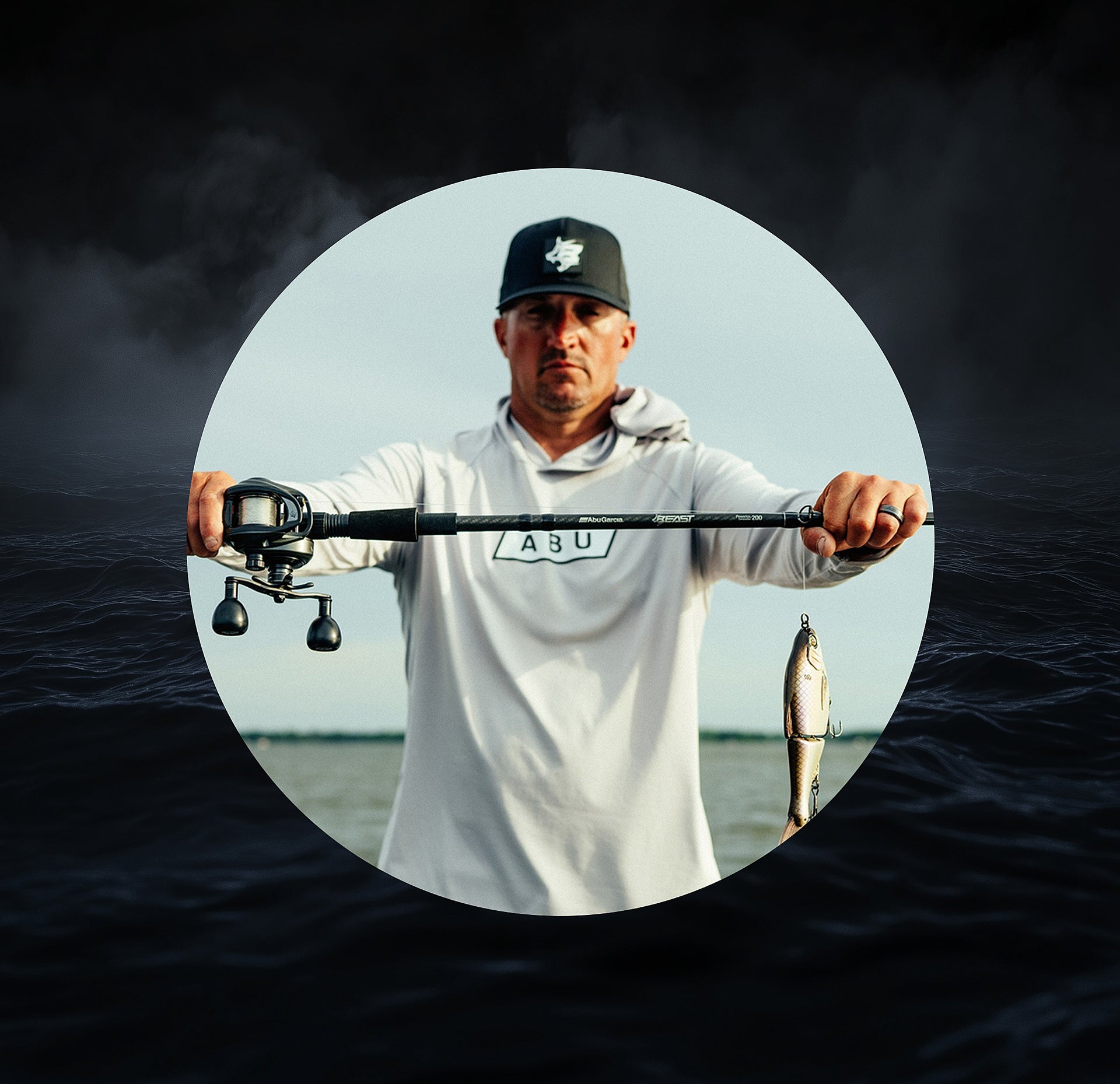 Man holding a Beast fishing rod with a fish on a dark water background
